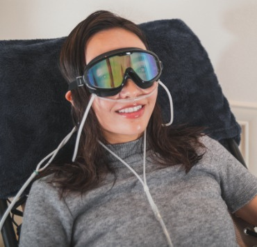 Person enjoying an HHO inhalation session with nasal cannula